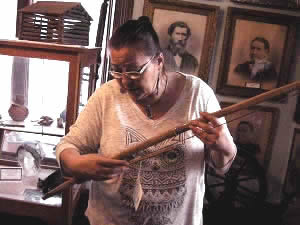 Mary Meyer looking at bow that belonged to Arapeen